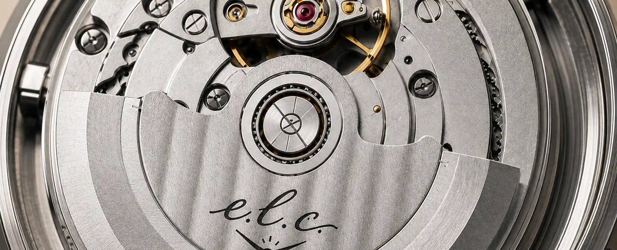 Close-up of the E.L.C. Riviera Signature automatic watch movement showing its mechanical gears, screws, and engraved rotor.