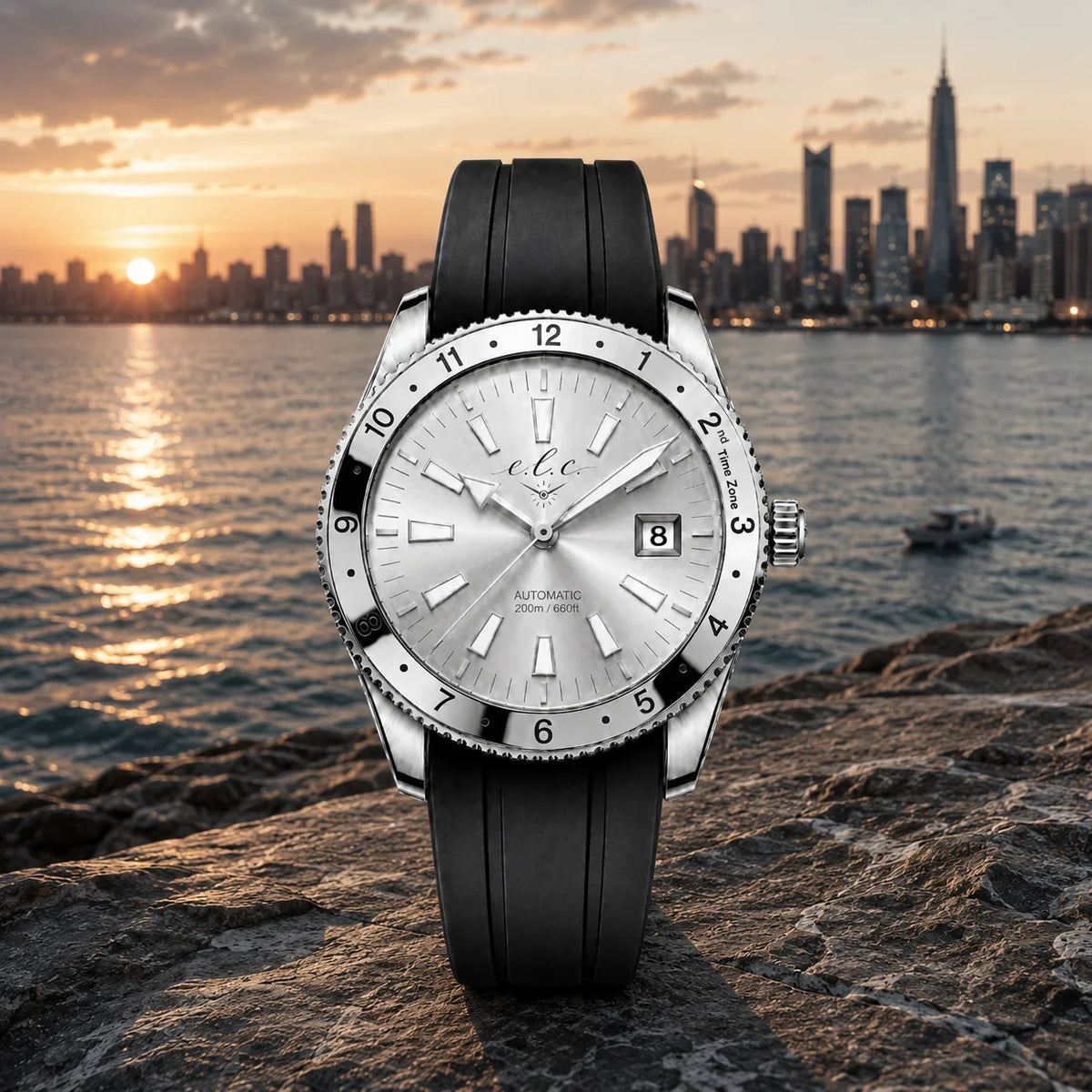 E.L.C. Riviera Signature Silver White watch with a silver dial, silver rotating bezel, and black rubber strap, displayed against a city skyline at sunset.