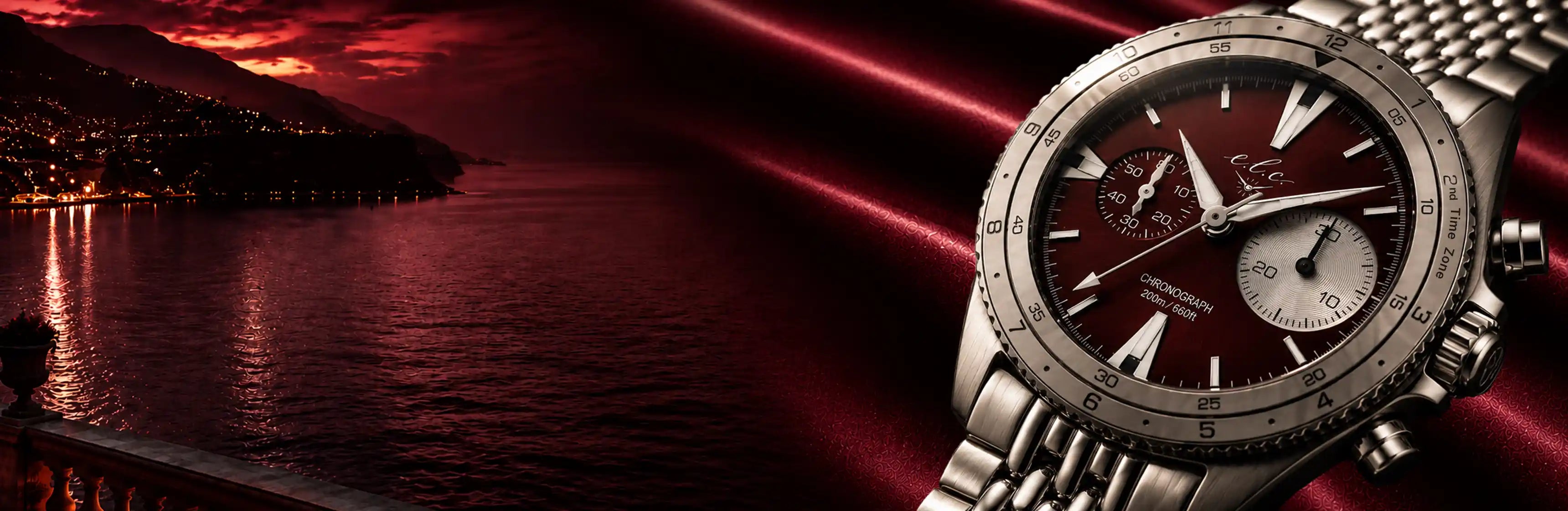 Luxury silver chronograph watch against a red sunset lake background